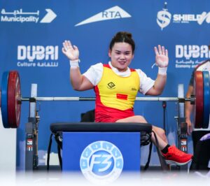 China's Guo Lingling celebrates after her world record breaking lift in Dubai.
