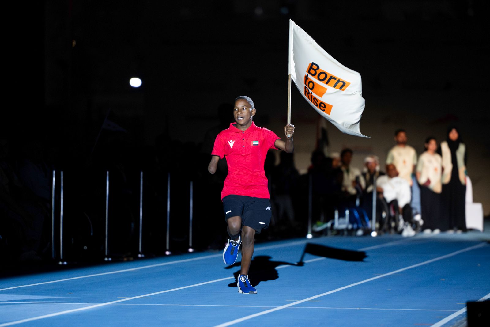 Darwish Al Rashidi runs with the AYPG Flag.
